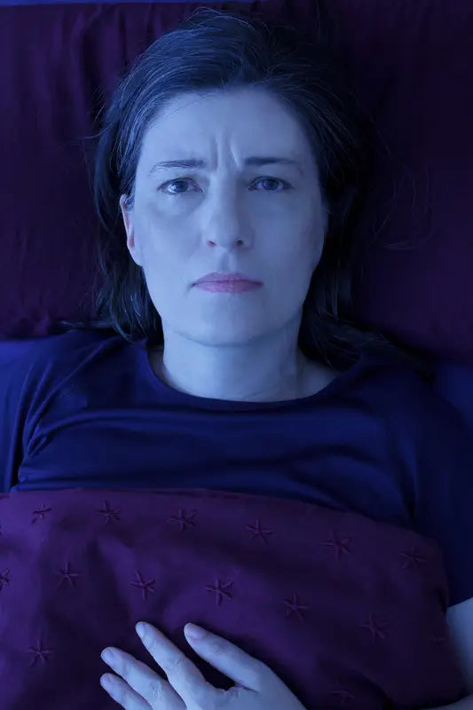 Person managing chronic pain and fatigue, illustrating an article on supplement strategies for fibromyalgia.